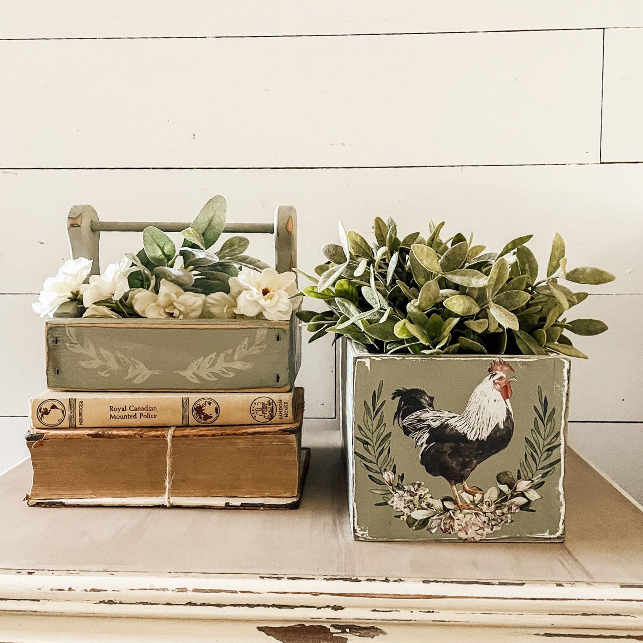 A vintage wood tool box and a wood flower planter box are painted light sage green and feature ReDesign with Prima's Morning Farmhouse small transfer on them.