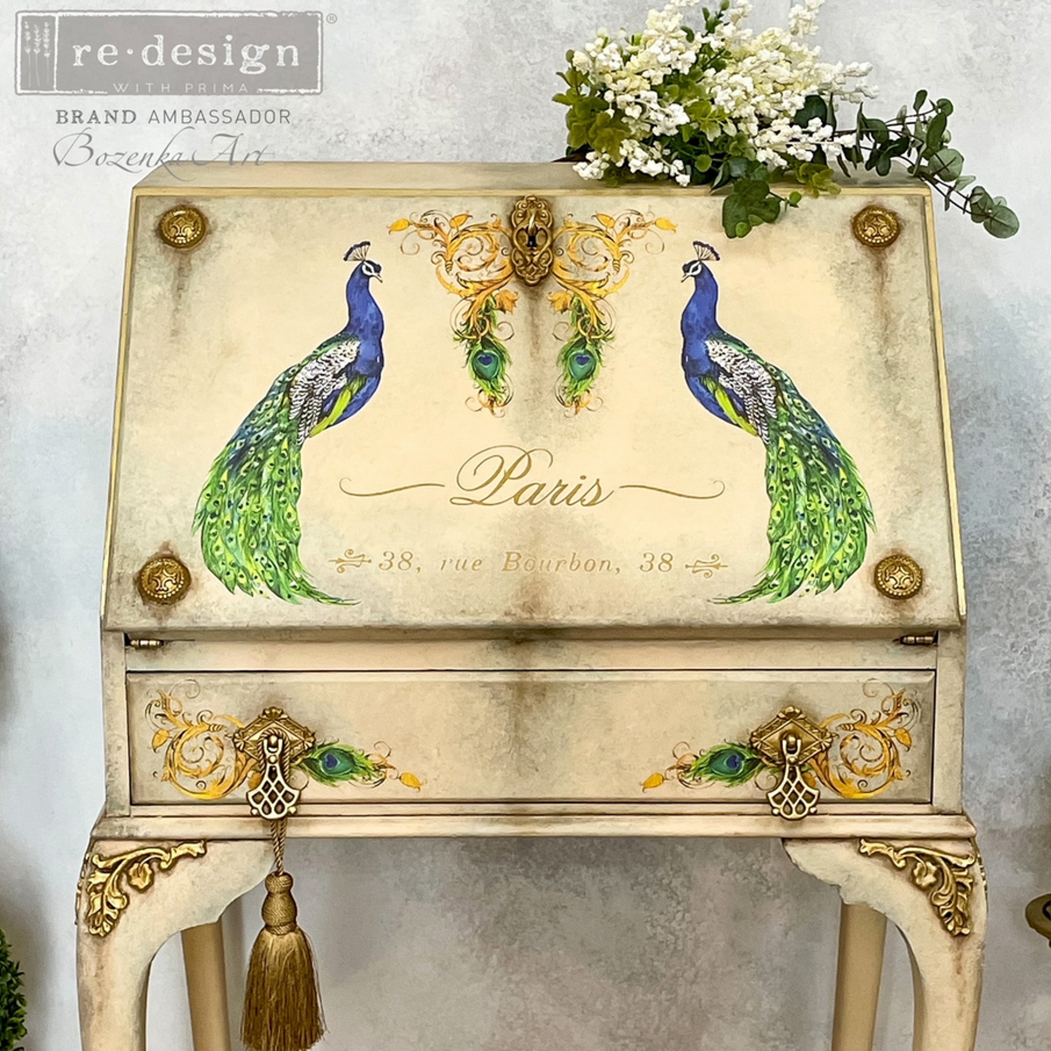 A vintage secretary's desk refurbished by Bozenka Art is painted light tan and features ReDesign with Prima's Peacock Paradise small transfer on it.