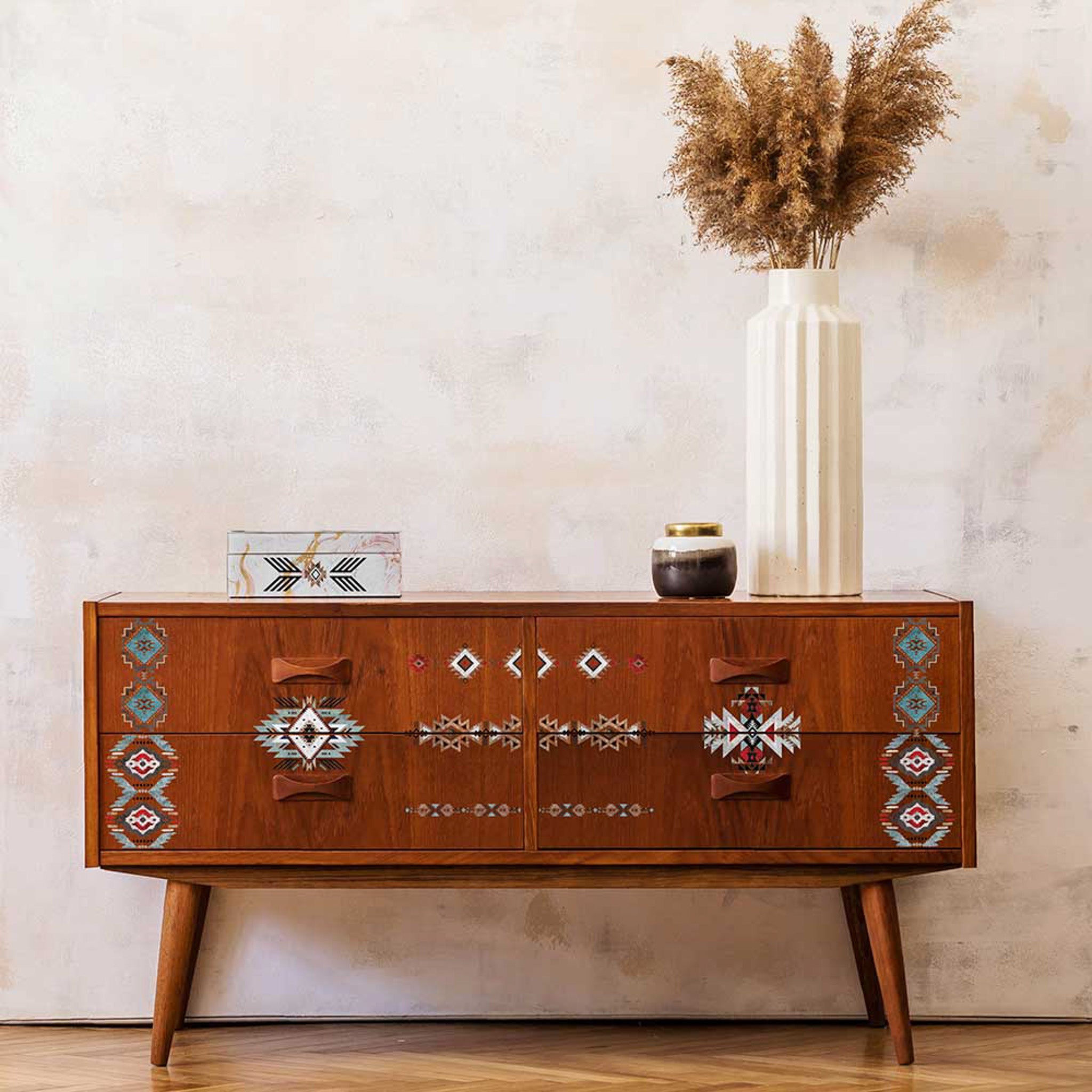 A 70's inspired console table is stained a dark natural wood and features ReDesign with Prima's Something Tribal transfer on it.