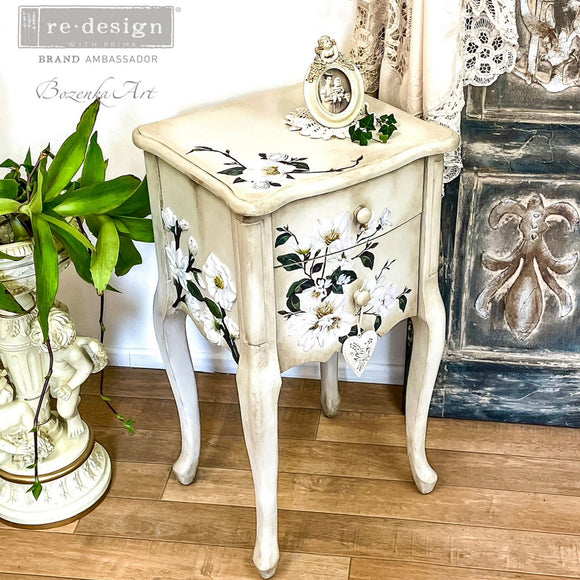 A vintage, small, 2-drawer nightstand refurbished by Bozenka Art is painted antique white and features ReDesign with Prima's White Magnolia Small transfer on it.