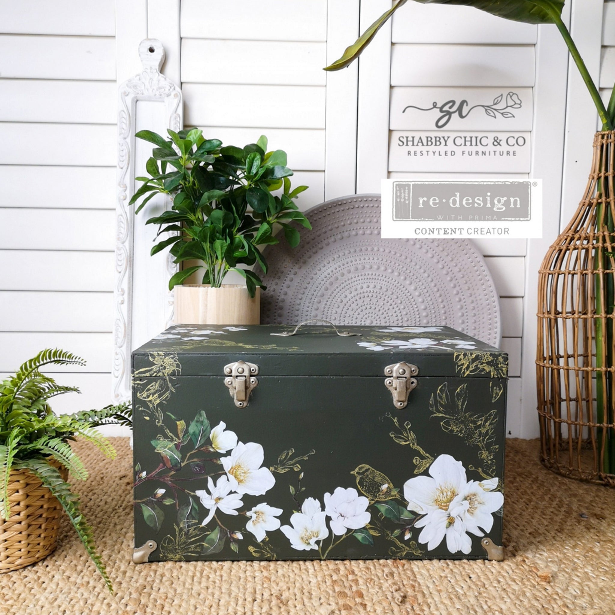 A vintage footlocker storage chest refurbished by Shabby Chic & Co. Restyled Furniture is painted hunter green and features ReDesign with Prima's White Magnolia small transfer on it.