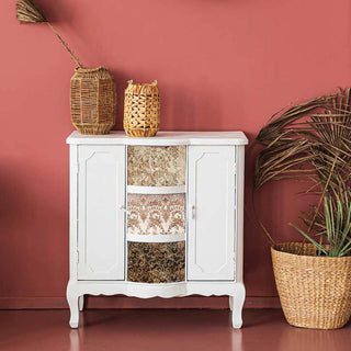 A vintage side table with 3 drawers and 2 doors is painted white and features the Delicate Lace small transfers on its drawers.