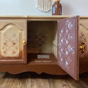 Vintage buffet table refurbished by Zaina's Interiors, a ReDesign Content Creator, is painted a blend of light and dark brown and features the Boho Vibes stencil on it.