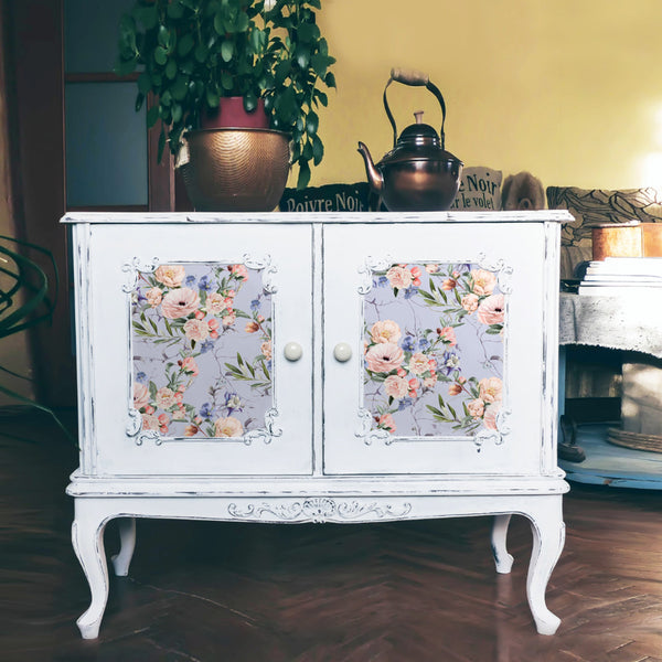 A small vintage console table is painted white and features the Lavender Fleur tissue paper on its doors.