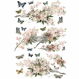 A pink blossoms branches and blue butterflies transfer design. A transparent Redesign with Prima diy simplified logo on top.