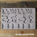 Wooden background with the Louelle Borders mold tray on top. A white Maika Daughters logo is in the bottom right corner.