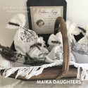 A brown basket that has white fabric sacks that has the classic vintage label transfer on them. Above in white lettering, it reads Los Mimis Armoire Shabby Chic & Vintage. In the bottom right corner in white lettering, it reads Maika Daughters.