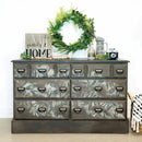 A large brown dresser with the radiant eucalyptus tissue paper design on top of the drawers.