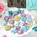 Colorful Curio Trinkets mold castings in a white bowl.