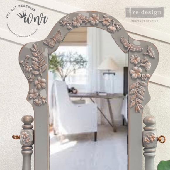A close-up of a vintage standing mirror refurbished by Why Not Redesign, a ReDesign with Prima Content Creator, is painted light grey and features the Cherry Blossoms silicone mould castings on it.