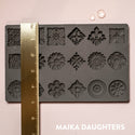 Curio Trinkets mold tray with a ruler measuring 5 inches in height. A white Maika Daughters logo on the bottom right.