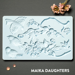 Aviary mold tray on a black background. A white Maika Daughters logo on the bottom right.