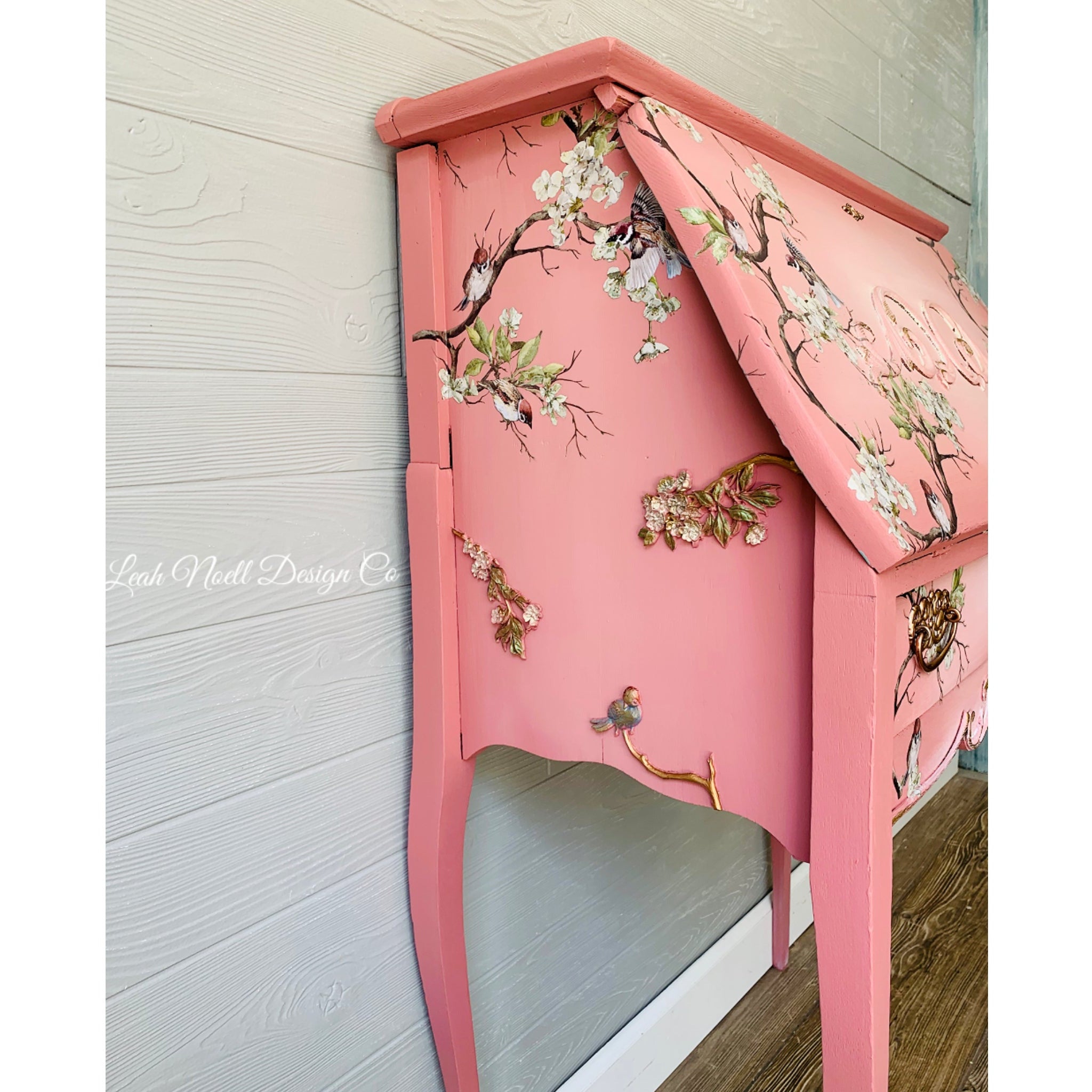 A vintage secretary desk refurbished by Leah Noell Design Co. is painted pink and features the Aviary silicone mould on it.