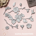 Silver colored castings of ReDesign with Prima's Cherry Blossoms silicone mould is against a light pink background.