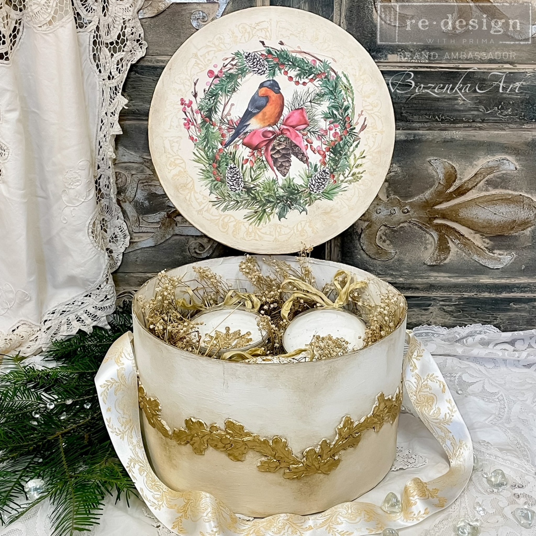 An open circle box refurbished by Bozenka Art is painted white with gold accents and features ReDesign with Prima's Louelle Borders in gold around the side.