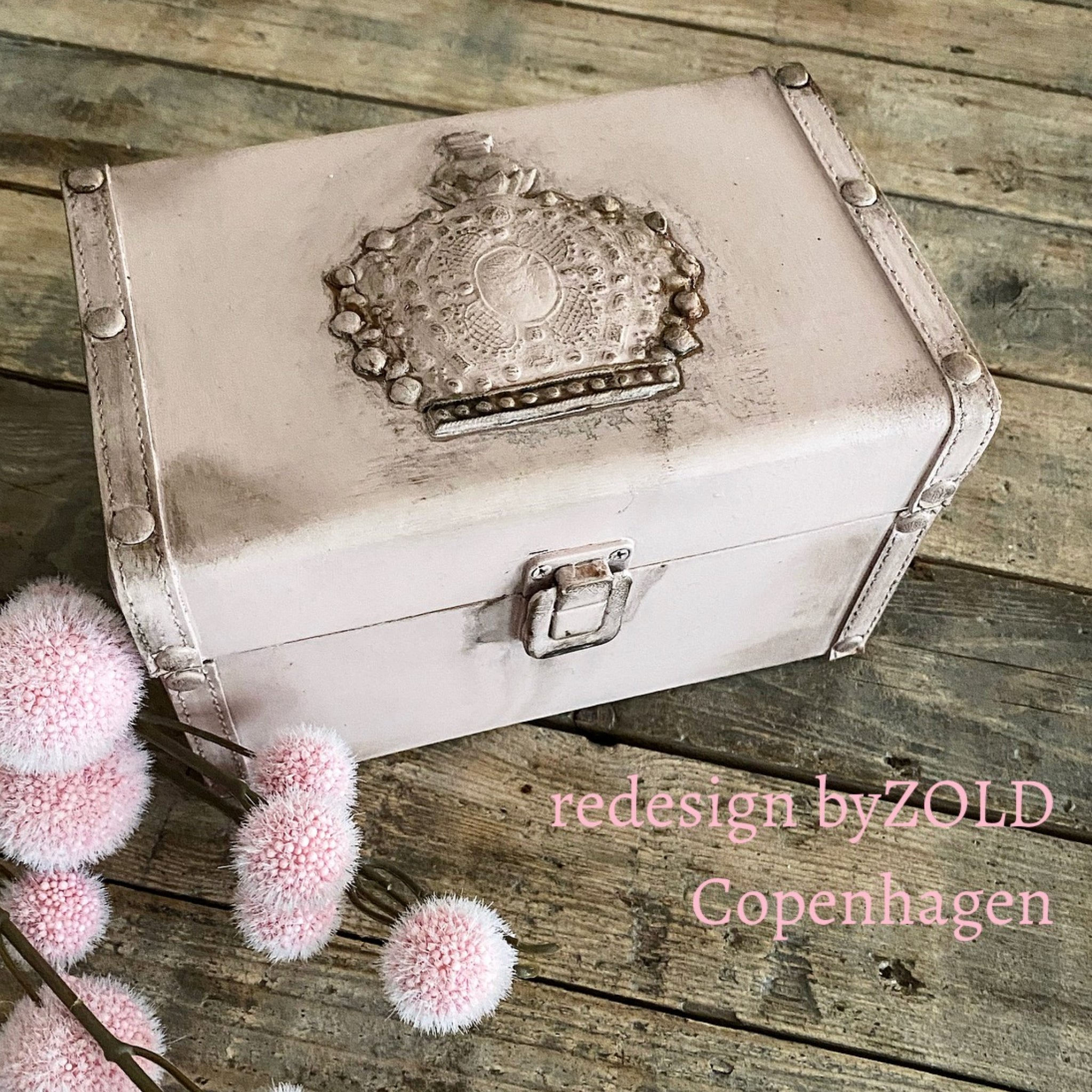 A vintage small leather storage box refurbished by Redesign by Zold Copenhagen is painted pale pink and features ReDesign with Prima's Victorian Adornments silicone casting.