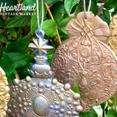 A close-up of ReDesign with Prima's Victorian Adornments silicone moulds against green foliage.