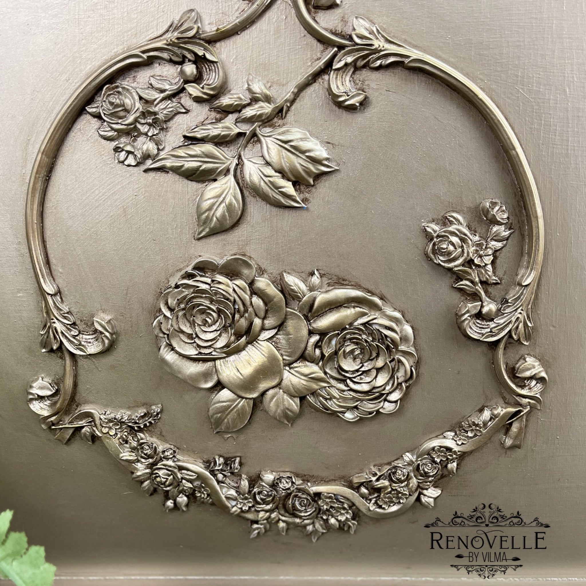 A close-up of a project refurbished by Renovelle by Vilma is painted in champagne gold and features ReDesign with Prima's Victorian Rose silicone mould.
