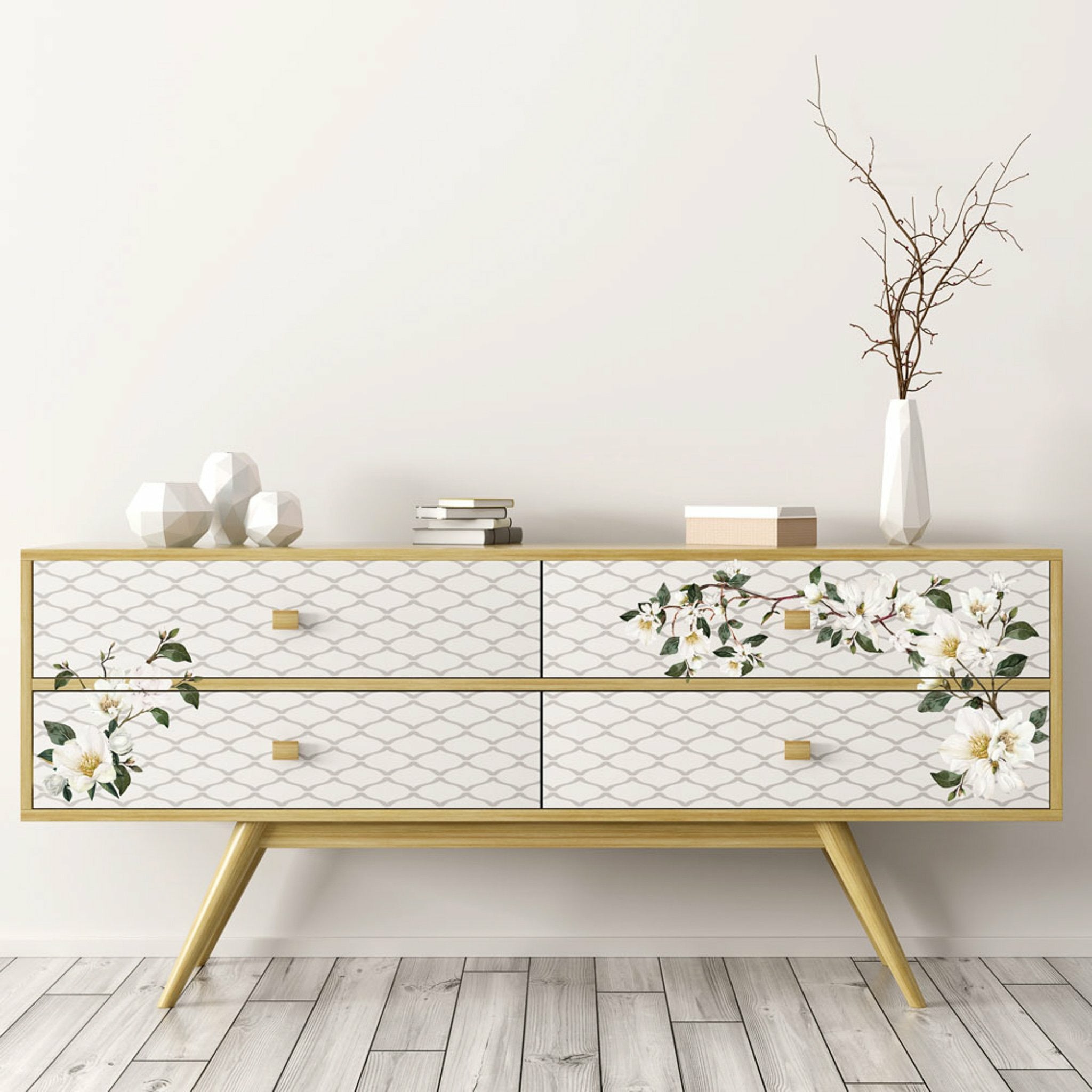 A modern style 4-drawer dresser is stained a natural wood and features ReDesign with Prima's White Magnolia small transfer on its drawers.