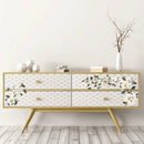 A modern style 4-drawer dresser is stained a natural wood and features ReDesign with Prima's White Magnolia small transfer on its drawers.