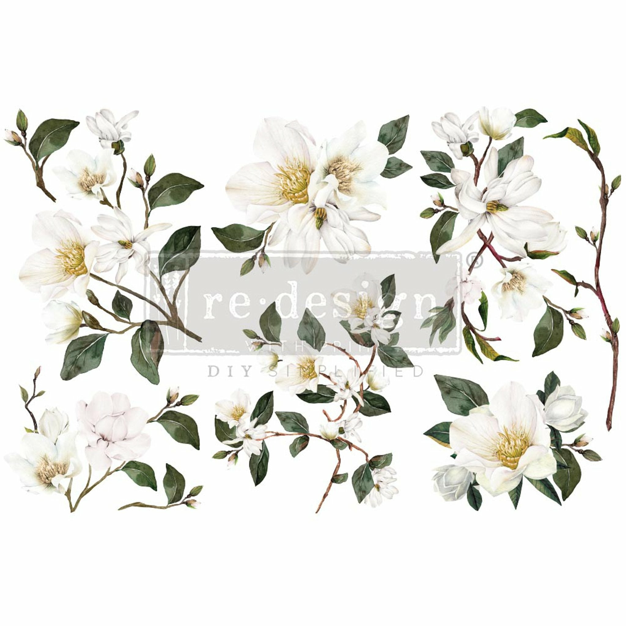 Small rub-on transfer design of white magnolia flowers on branches with green foliage. White borders are on the top and bottom.