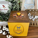 A yellow and wood furniture piece with the Autumn Essentials transfer on top. A redesign logo is in the top left corner along with a chicken logo reading: Rosie's Rusties.