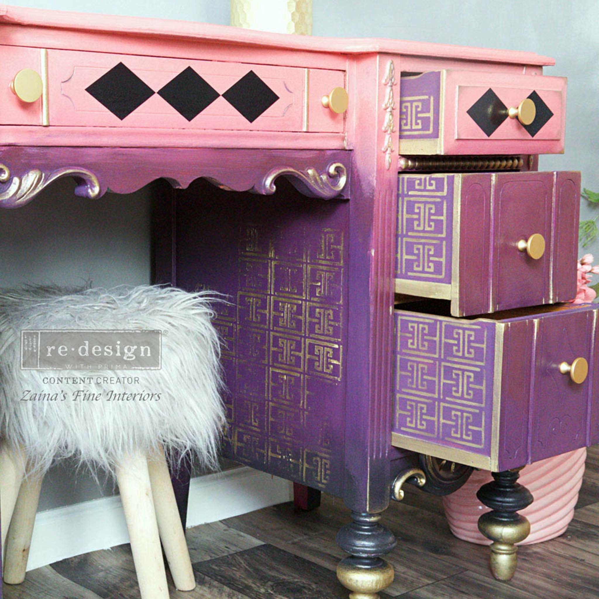Pink and purple ombre dresser with the Something Geometric stencil on top. A Redesign Zainas Fine Interiors logo on the left.