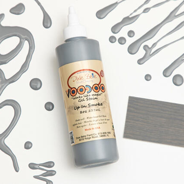 Dixie Belle's Up In Smoke Voodoo Gel Stain is against a white background with a wood stained swatch and a poured color sample.